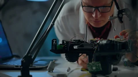 Engineer works on robotics project in a modern workshop Stock Footage 293734662