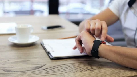 The engineer works with a smart clock and with a phone Stock Footage 90952131