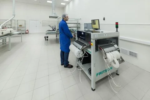 The engineer works for the Surface Mount Technology machine Stock Photos