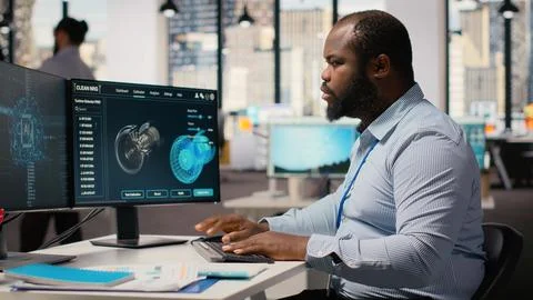 Engineer works on wind turbine simulation using artificial intelligence Stock Photos