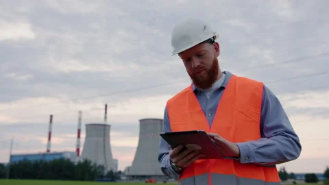 The engineer writes data about the operation of electrical equipment to a tablet Stock Footage 201483791