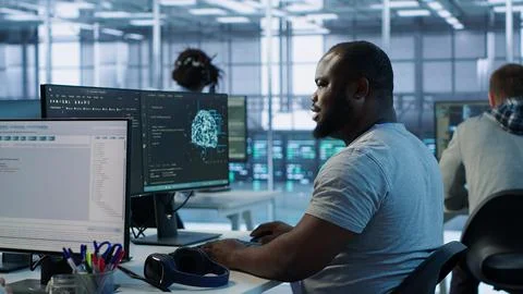 Engineer writing code and doing checkup on server room 写真素材