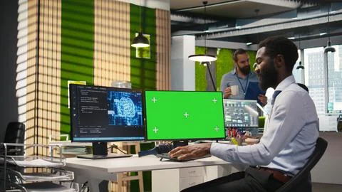 Engineer writing code on green screen PC, developing machine learning APIs Stock Photos