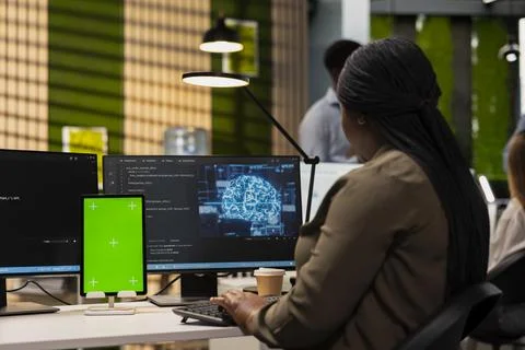 Engineer writing code on green screen tablet, developing machine learning APIs Foto stock