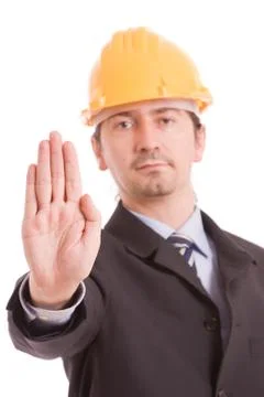 Engineer with yellow hat making stop sign Stock Photos
