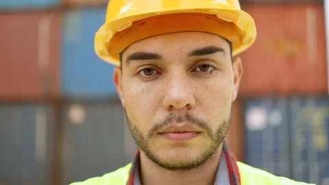 Engineer young industrial worker man smiling at camera at shipping freight Stock Footage 182579118