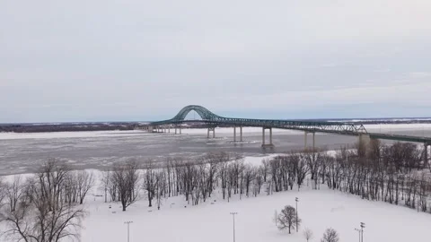 Engineering bridge cables over icy river minimal aerial Stock Footage 329395397