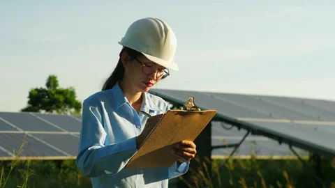 Engineering checking Solar cell Farm, standing near sun panels. Stock Footage 119074140