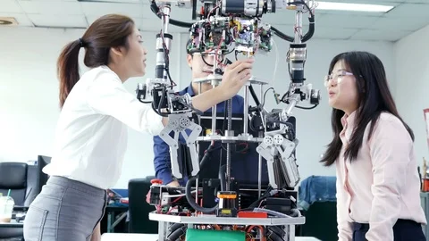 Engineering collaborating on develop of robot in laboratory. Stock Footage 94069045