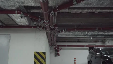 Engineering communications. Sewer pipes in the parking lot of a building Stock Footage 249963311