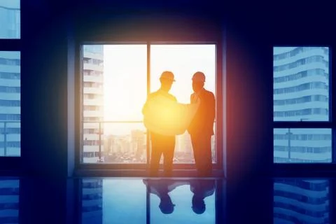 Engineering concept two men big office window Stock Photos