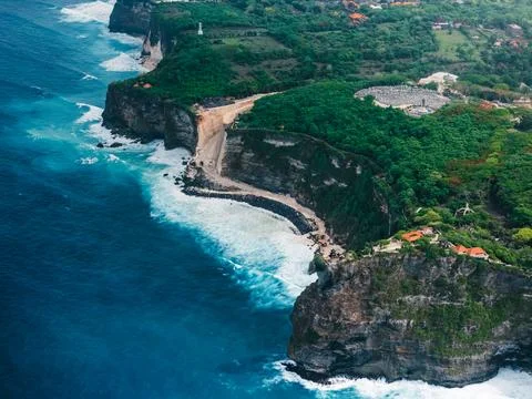Engineering construction on the cliff under Uluwatu temple in Bali. Drone vie Stock Photos