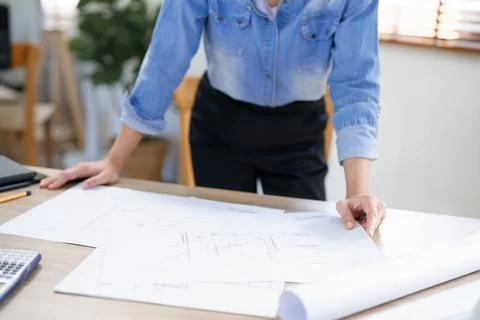 Engineering construction concept, Female engineer is checking blueprint of co Stock Photos