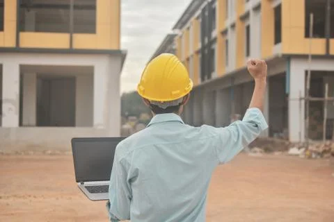 Engineering construction holding computer notebook inspection work at estate  Stock Photos
