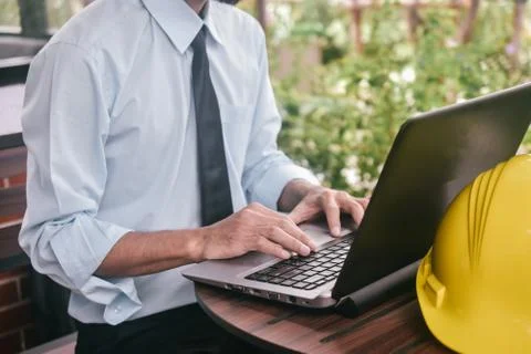 Engineering construction holding computer notebook inspection work at estate  Stock Photos