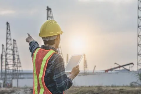 Engineering construction  holding tablet Posting cranes for pile construction Stock Photos