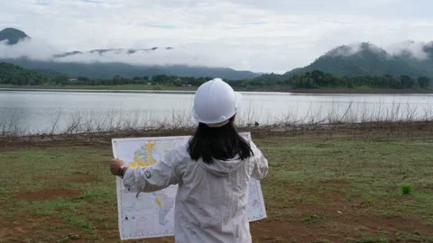 Engineering holding a riverbank map to develop a hydroelectric dam. Stock Footage 204413773