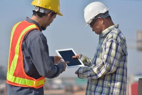 Engineering holding tablet work on road construction Stock Photos