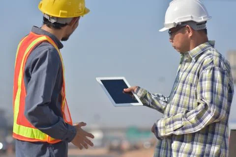 Engineering holding tablet work on road construction Stock Photos