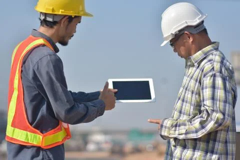 Engineering holding tablet work on road construction Stock Photos