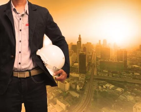 Engineering man and sun light behind urban construction background use for la Stock-Fotos