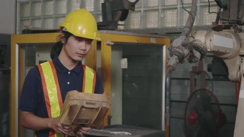 Engineering man check and control welding robotics automatic arms machine for Stock Footage 149023022