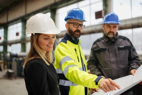 Engineering manager and mechanic worker doing routine check up in industrial Stock Photos
