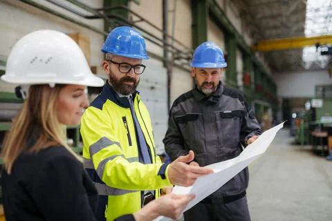 Engineering manager and mechanic worker doing routine check up in industrial Stock Photos