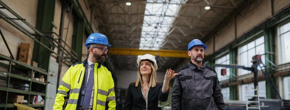Engineering manager and mechanic worker doing routine check up in industrial Stock Photos