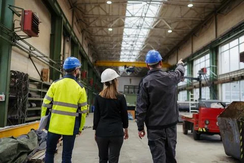 Engineering manager and mechanic worker doing routine check up in industrial Stock Photos