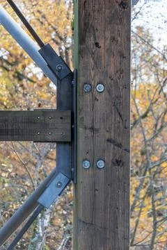 An engineering node for connecting wood and metal in a street structure. Stock Photos