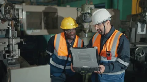 Engineering or mechanical using laptop set up machine control systems in factory Stock Footage 330398056