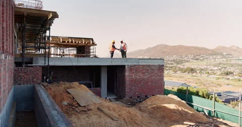 Engineering, people and handshake at construction site with success, discussion Stock Footage 336219944