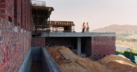 Engineering, people and plan at construction site with building inspection Stock Footage 336205066