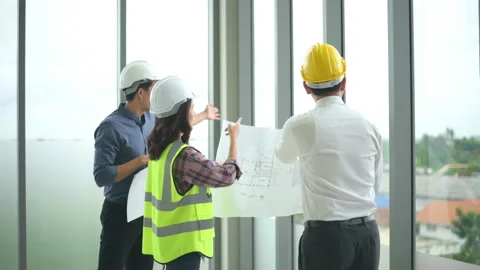 Engineering people are analytics construction plans with blueprint in office Stock Footage 137866728