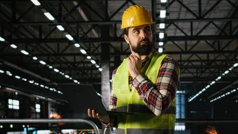 Engineering plant staff with hard hat inspecting heavy machinery Stock Photos