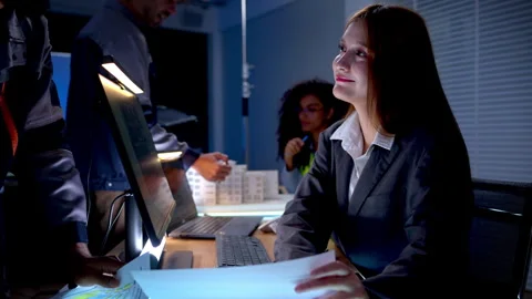 Engineering professionals reviewing architectural plans and digital project Stock Footage 340463718