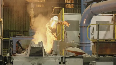 Engineering Steel Foundry Worker Stirring Glowing Metal in Furnace Bay Видео 344997883