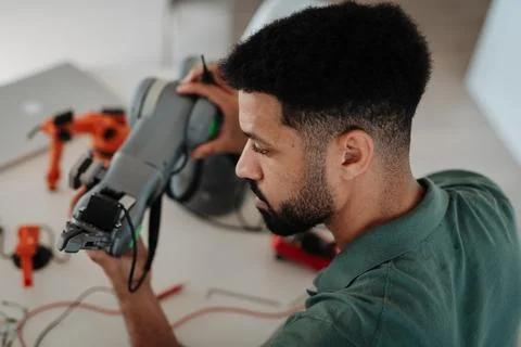Engineering student creating and calibrating a robotic arm Stock Photos