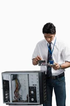Engineering student examining a computer board before assembling Stock Photos