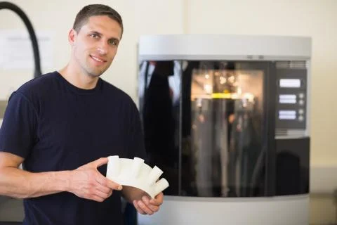 Engineering student holding object printed from 3d printer Stock Photos