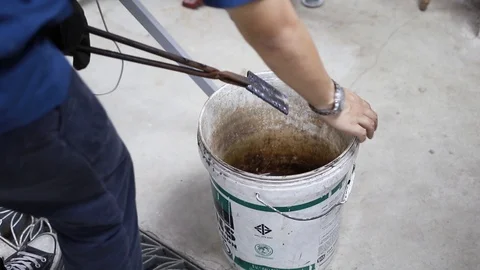 An engineering student put hot welded metal into the water Vídeo Stock 97983606