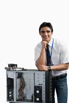 Engineering student standing with a computer cabinet Stock Photos