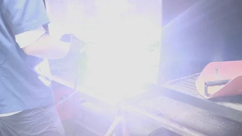 An engineering student welding a piece of metal Stock Footage 97986279