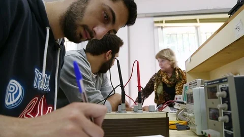 Engineering student writes notes on experiments inside lab Vídeos de archivo 120606450