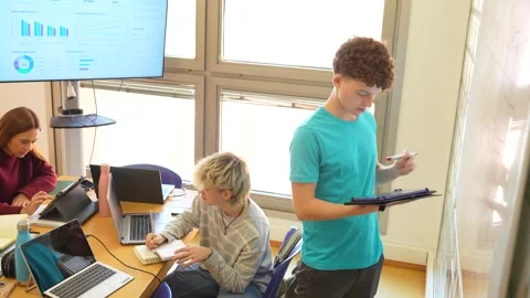 Engineering students collaborating in a modern classroom Stock Footage 347893777