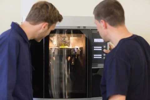 Engineering students using 3d printer Stock Photos