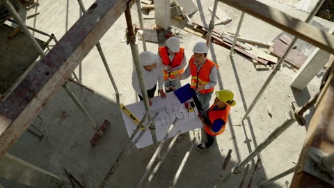 Engineering team Along with the architect and foreman watching the Blue Print Stock Footage 169460831