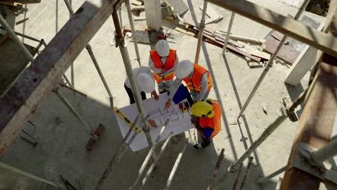 Engineering team Along with the architect and foreman watching the Blue Print Stock Footage 169764173