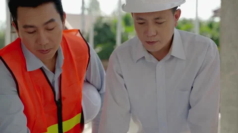 Engineering team Along with the architect and foreman watching the Blue Print Stock Footage 170346404